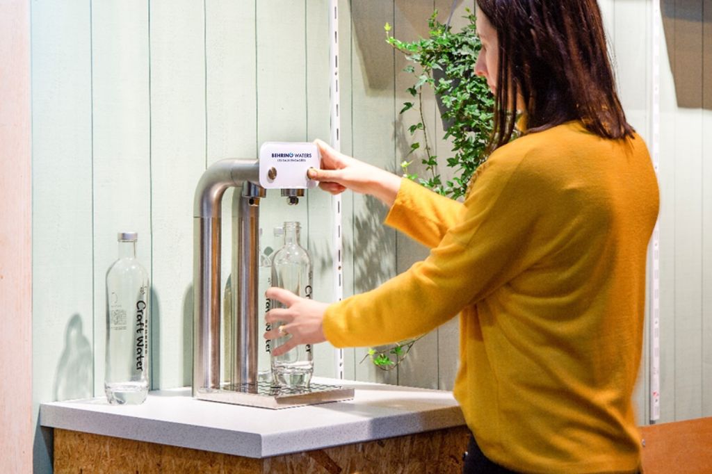 Femme se servant à la fontaine